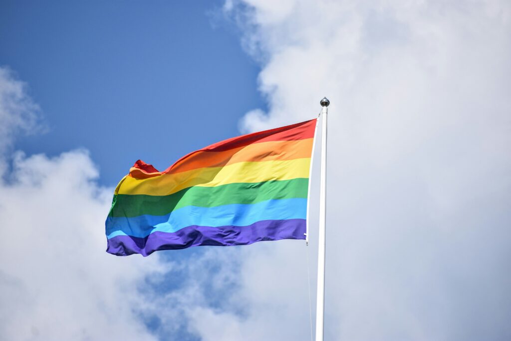 A rainbow flag flutters in the wind. This could represent the importance of LGBTQ therapy in Boulder, CO and being an ally. Learn how an LGBTQ therapist in Boulder, CO can offer support by searching for Boulder counseling.