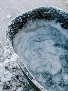 An open hole of water on an ice covered lake. Learn more about how cold plunging can offer support with anxiety by contacting an anxiety therapist in Boulder, CO. Search for Boulder counseling by searching for signs of depression in Boulder, CO. 