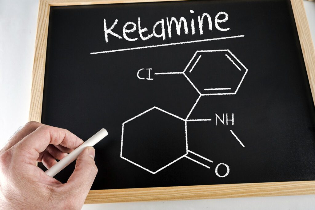 A close up of a chalkboard with a drawing of the molecular structure of ketamine. Learn more about the scientific benefits of ketamine therapy in Boulder, CO by contacting a ketamine therapist in Boulder, CO today. They can offer ketamine assisted therapy in Boulder, CO and other services.
